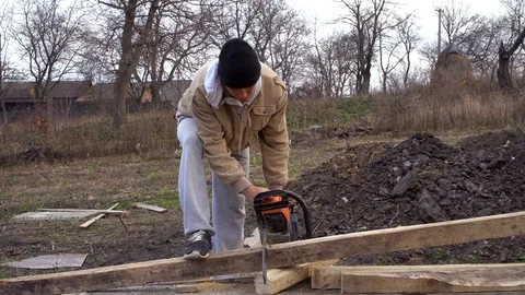 A person , man using a chainsaw cut log Stock Footage 120253379