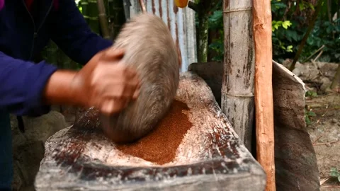 Person manually grinding old style coffee in a stone mortar Video stock 202178497