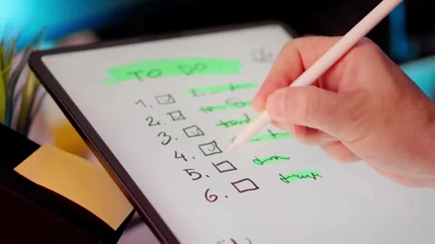 Person marking a to do list on a digital tablet screen Stock Footage 334572419