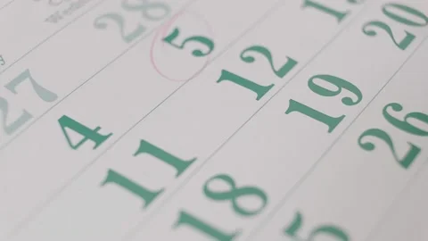 Person marking important dates on the calendar with a red pencil. Stock Footage 146548856