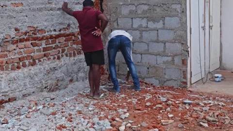 Person is marking the position of a structural column on construction site. day Stock Footage 312799462