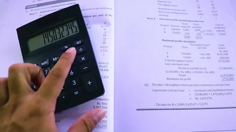 A Person Marking Some Important Things On The Book While Calculating Stock Footage 170153452