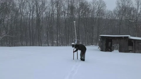 A Person Measures the Depth of Snow Stock Footage 146044933