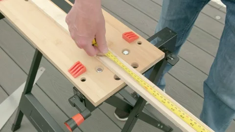 Person measures wood on a workbench Stock Footage 342056302