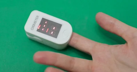 Person is measuring level of oxygen saturation of blood with a pulse oximeter. Stock Footage 145445746