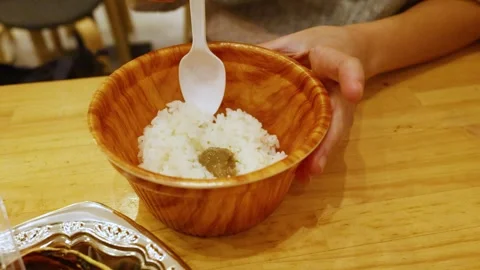 Person Mixing Crab Miso Paste into a Bowl of White Rice Video stock 331413305