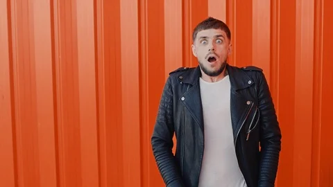 Person with a mustache and beard is shocked and surprised, then starts laughing Stock Footage 104074953