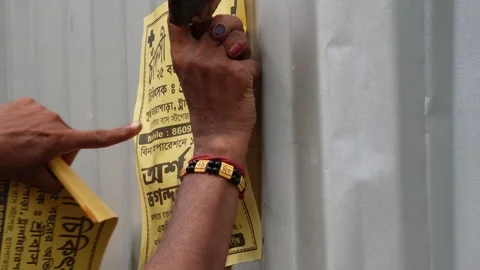Person Nailing Yellow Poster Stock Footage 340751660