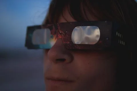 Person observing a celestial event using protective eclipse glasses, watchi.. Stock Photos