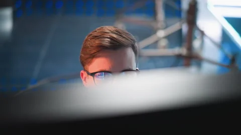 Person Observing Video Control Panel in TV Studio with Screen Reflection Stock Footage 317551969