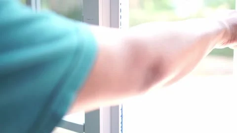 A person open a modern window handle inside a house with natural light. Stock Footage 339122340