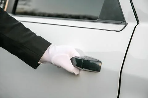 A person is opening a car door Stock Photos