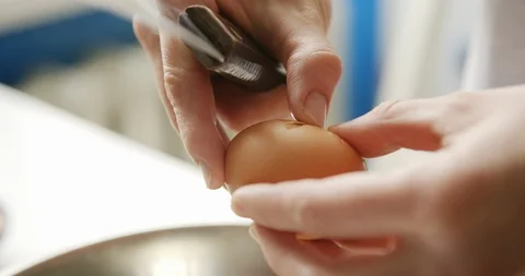 Person opening the egg with the knife Stock Footage 105126695