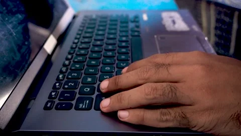 A person opening a laptop computer and starting to work, capturing daily of.. Stock Footage 340489894