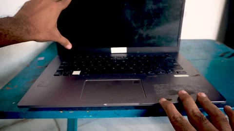 A person opening a laptop computer on a desk, capturing the start of a work.. Stock Footage 340489835