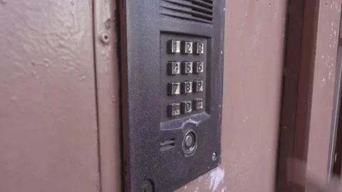 A person opens the door by entering a code of numbers. Stock Footage 101865161