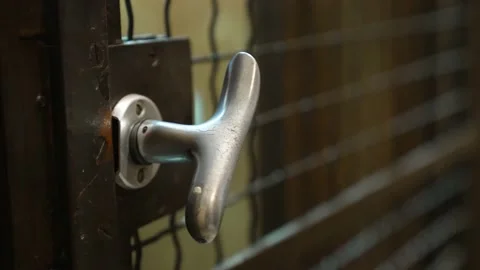 A person opens the door handle of the old vintage elevator, enters the Stock Footage 150576639