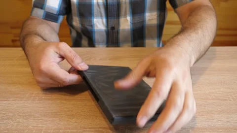 Person opens an empty plastic DVD case. The original audio captures the disti Stock Footage 341231563