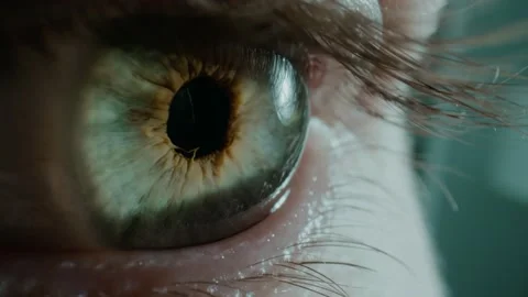 Person opens green eye staring at something in light studio Stock Footage 157227966