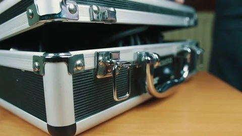 The person opens a suitcase with wires Stock Footage 70603174