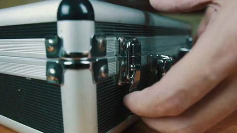 The person opens a suitcase with wires Stock Footage 70604150