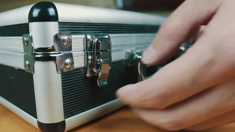 The person opens a suitcase with wires Stock Footage 70604382