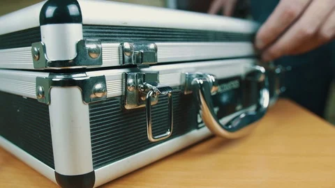 The person opens a suitcase with wires Stock Footage 70604415