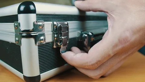 The person opens a suitcase with wires Stock Footage 70604594