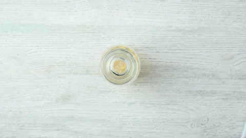 Person opens transparent flask and takes fish oil pills Stock Footage 128985548