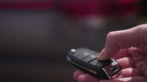 Person opens the trunk of the car with a remote access key. Close-up. Travel by 库存影片 194115524