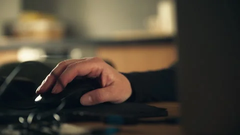 Person operating desktop computer with mouse in low light workspace, produc.. Stock Footage 346077460