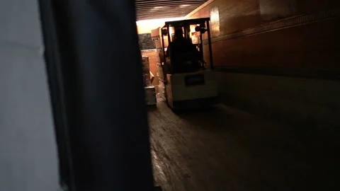 Person operating a small forklift in a dimly lit tunnel Stock Footage 152922151