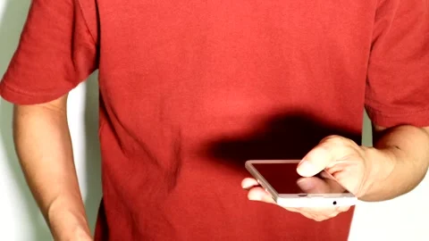 A person operating a smartphone while holding a wad of cash. Stock Footage 334694335