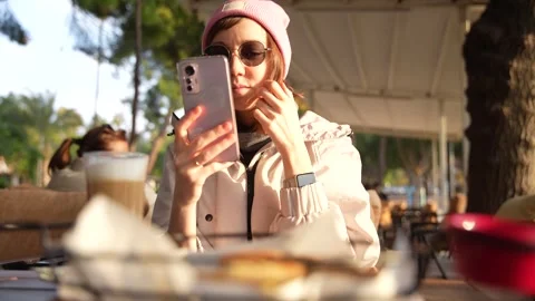 Person in outdoors cafe using smart phone. Stock Footage 254919085