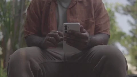 Person outdoors using a smartphone for digital banking Vídeo Stock 341441856