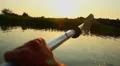Person paddling boat, enjoying beautiful sunset on river, POV HD Footage