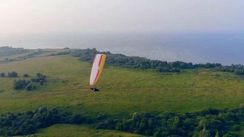 A person on a paraplane is doing tricks while flying. Parachute, paragliding Video stock 114173875