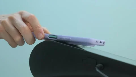 Person paying using smart phone touching card reader in shop Stock Footage 245580681