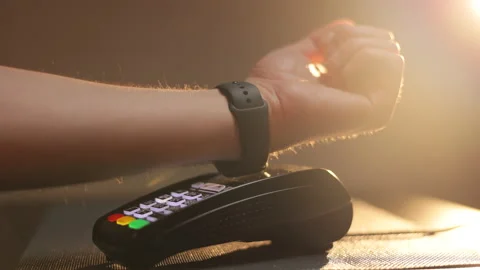 Person pays in a cafe using an electronic smartwatch. Contactless technology NFC Stock Footage 194550046