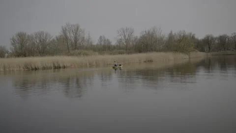 Person pedalling on a River Stock Footage 203917745