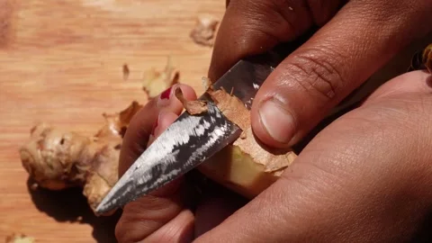 Person peeling ginger root 스톡 동영상 332575716