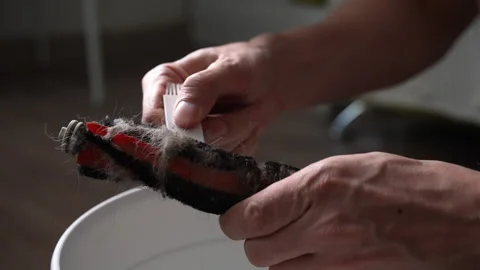 Person performing routine maintenance on home appliance, using special tool to Vídeo Stock 342755575