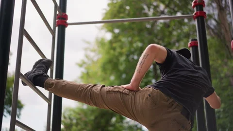 Person Performs Swift Vault Over Fitness Bars In Open Area, Athletic Man Stock Footage 327169452