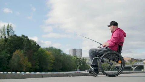 Person With A Physical Disability Who Uses Wheelchair Fishing From