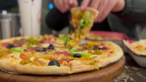 Person Picking Up a Pizza Slice Stock Footage 297730795