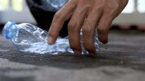 Person picking up plastic bottle into the trash , Recycling concept. Stock Footage 119324726