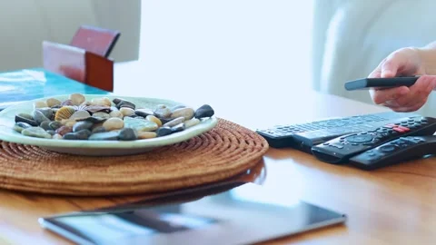 Person Picking Up Remote Control from Coffee Table 스톡 동영상 314928574