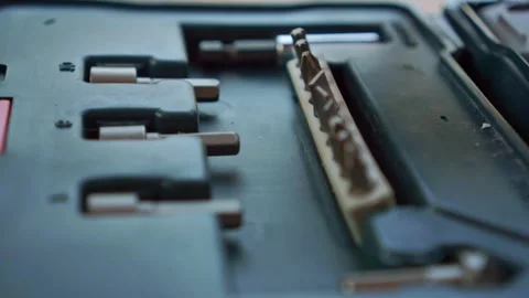 Person picking up screwdriver bit from organized toolbox, close up view, Stock Footage 345293621