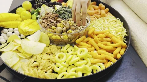 Person picking up seeds and nuts from a large tray on a desk Stock Footage 345146375
