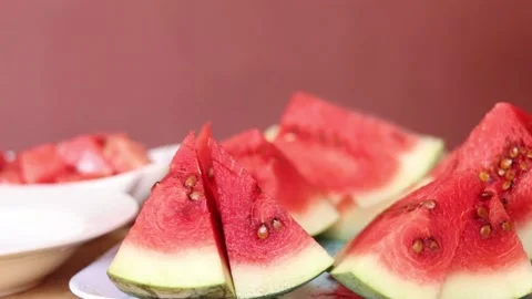 Person picking water melon slice from a bowl. Hand holding water melon Stock Footage 205530674